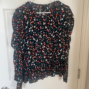 Floral blouse with ruched sleeves.